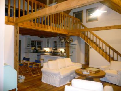 The kitchen is appointed with a Jenn Aire stove set into a custom island and the loft has a sitting room, double pull-out couch, private bathroom, and 9 ft. sliding glass doors leading to deck overlooking the sea.